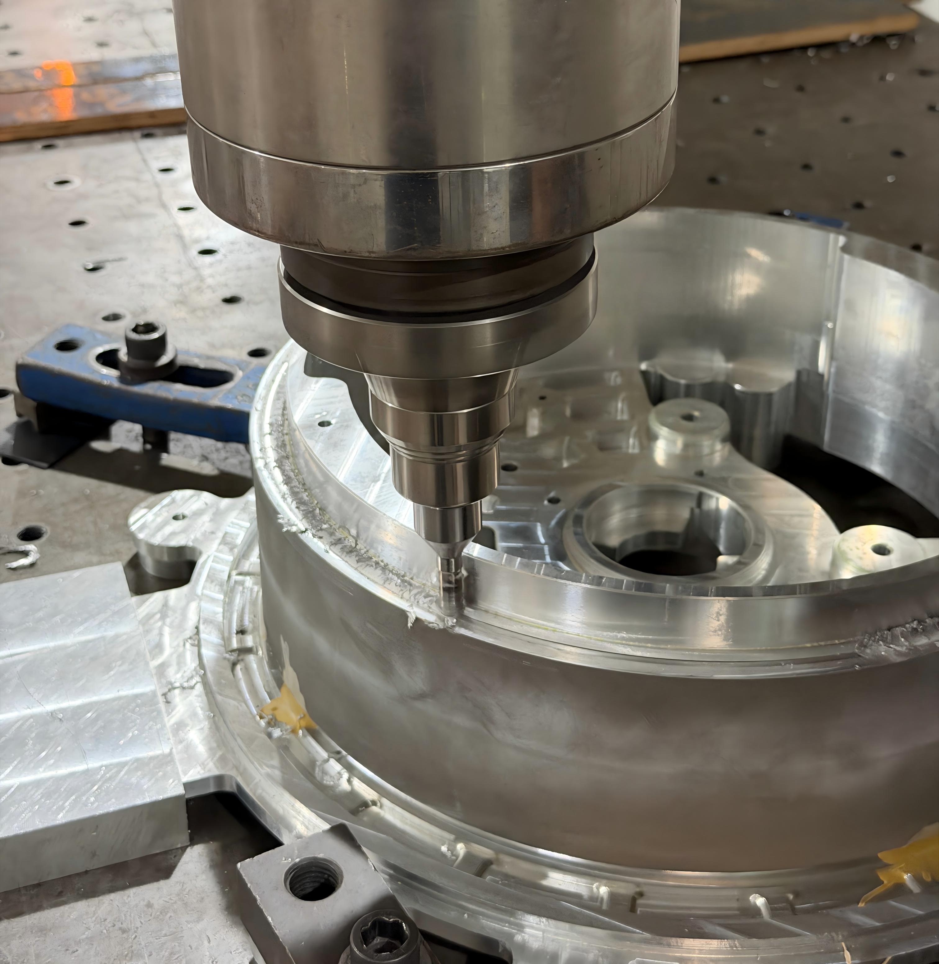 FSW tool welding a circular aluminum component during friction stir welding